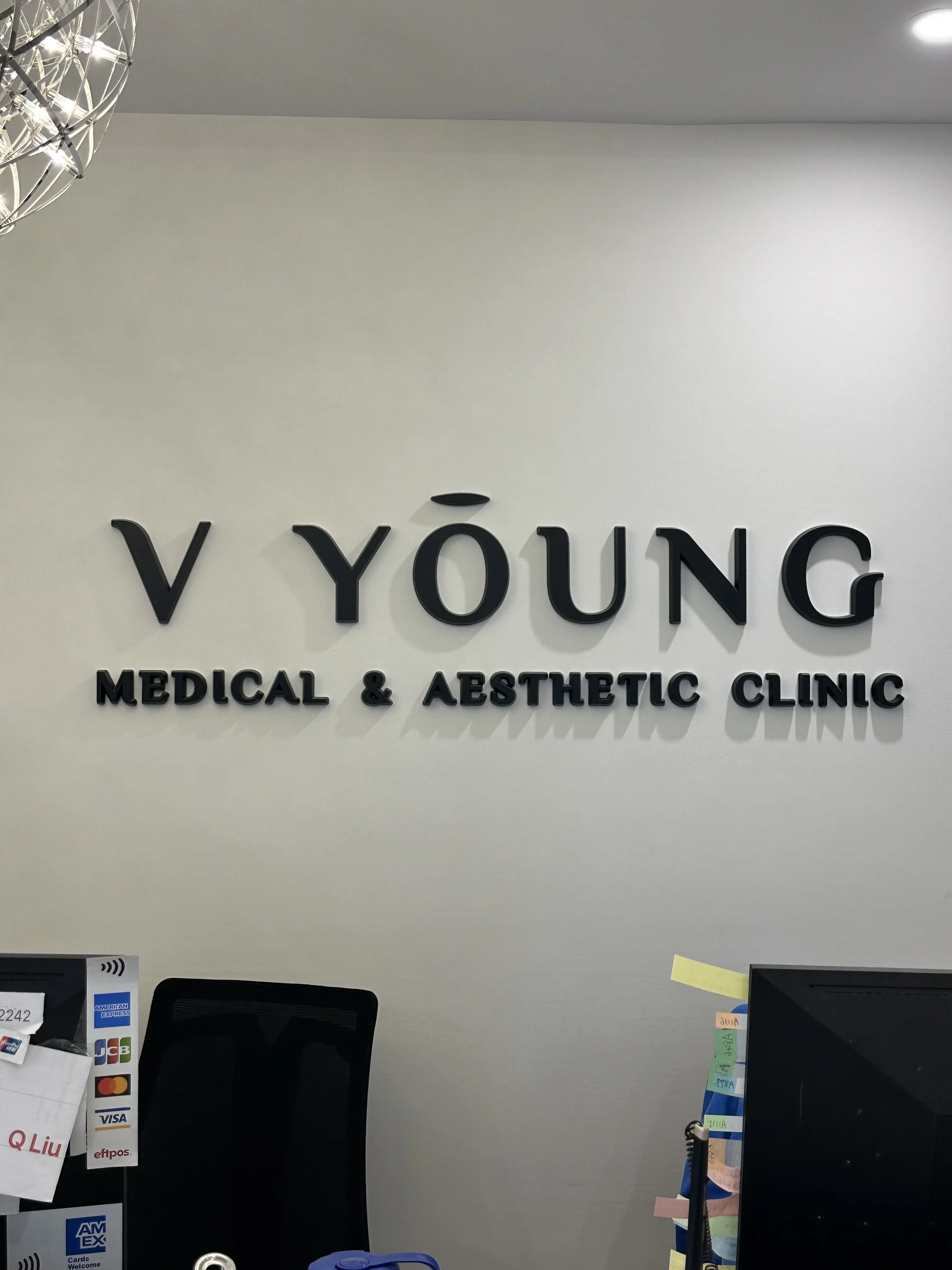Dimensional V Young Medical and Aesthetic Clinic wordmark on the reception wall