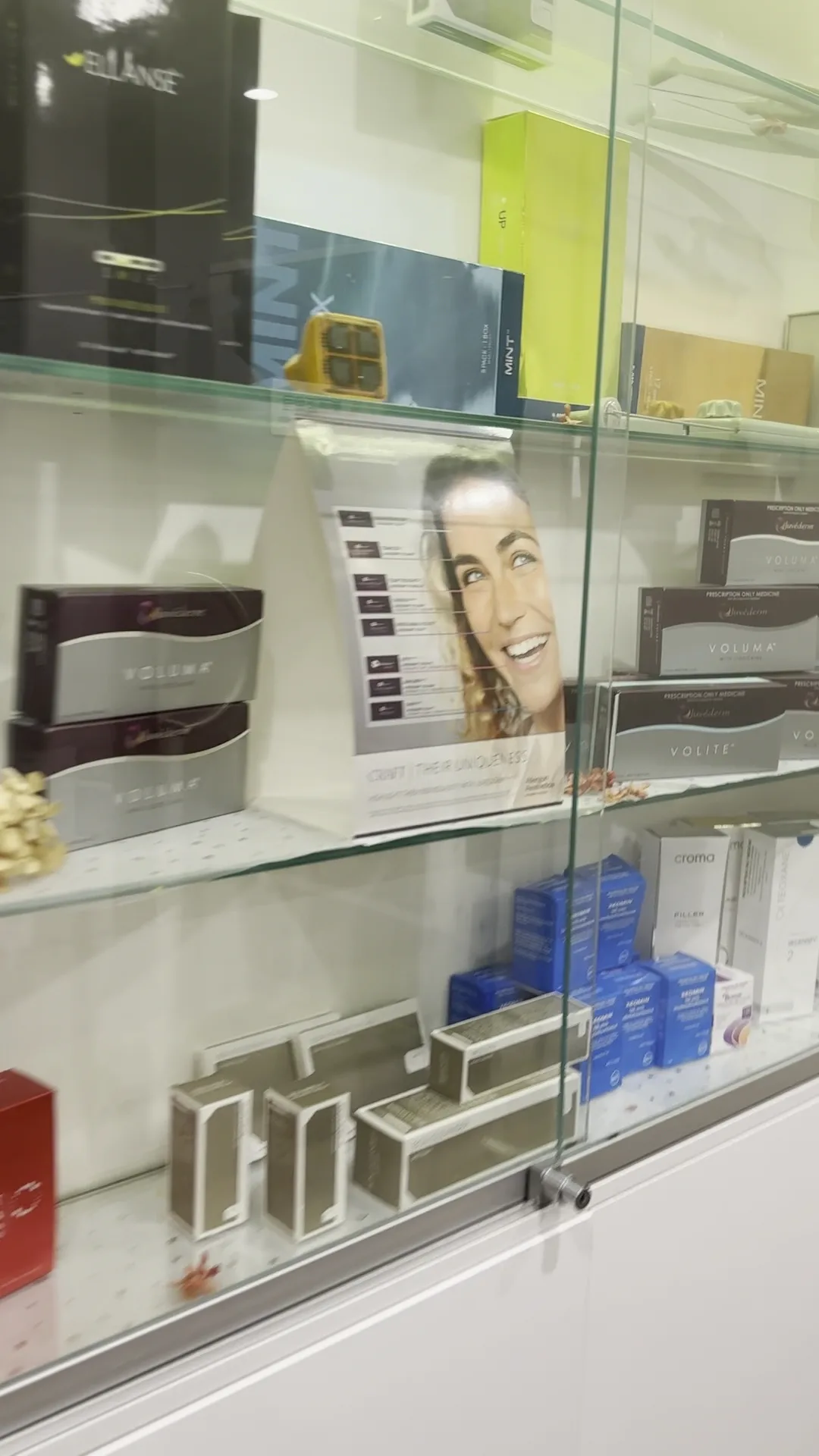 Glass cabinet of in-clinic injectable stock including Juvederm Voluma, Volite, Croma Filler, Ellanse and MINT PDO threads