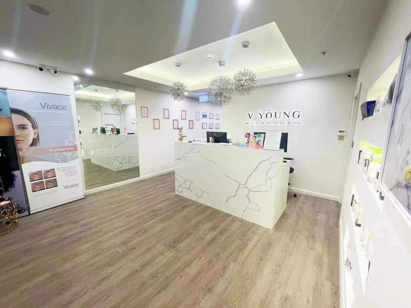 Reception desk with marble counter, Vivace treatment roll-up banner and skincare product shelves