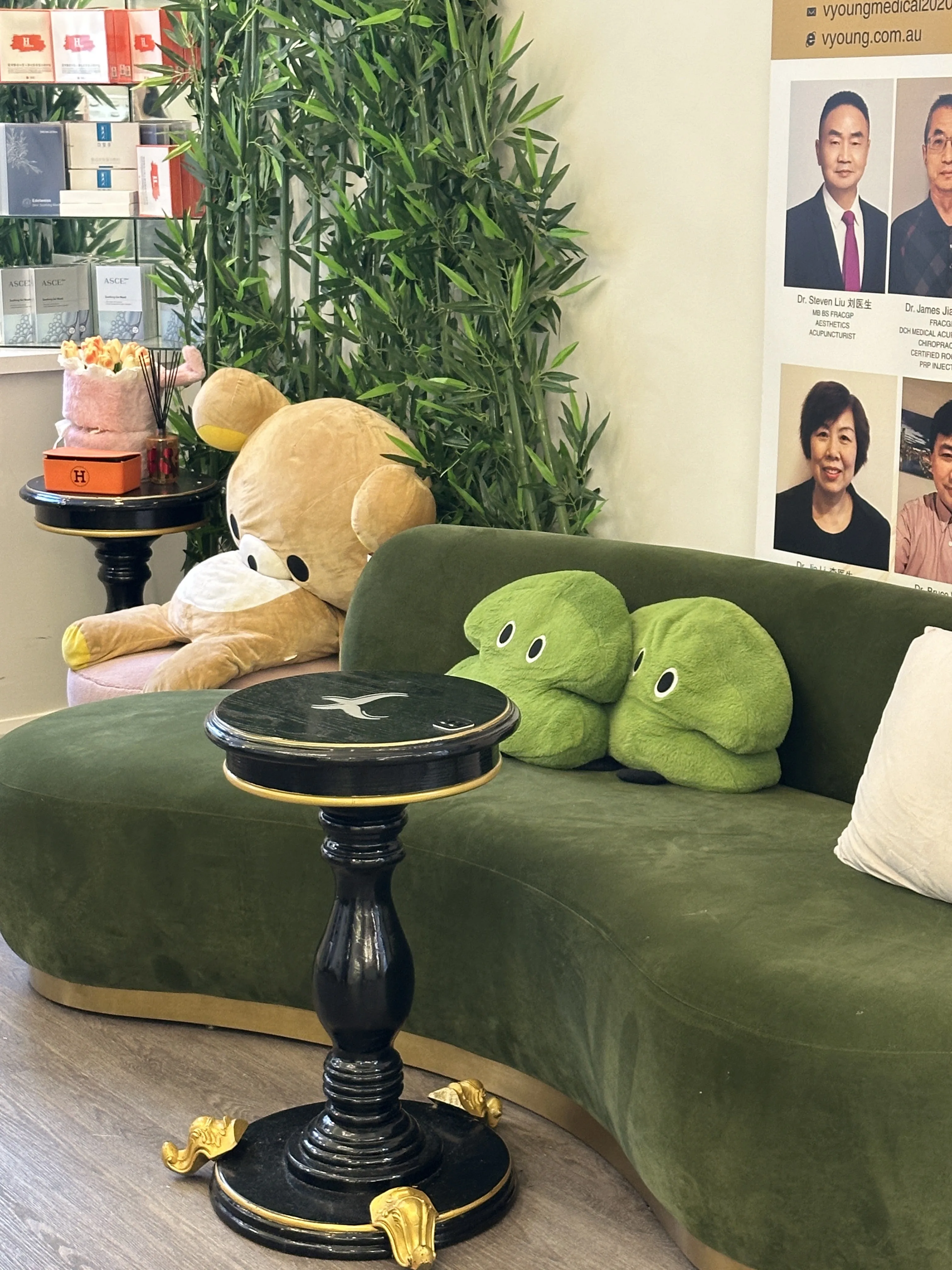 Curved green velvet sofa and plush toys in the waiting lounge